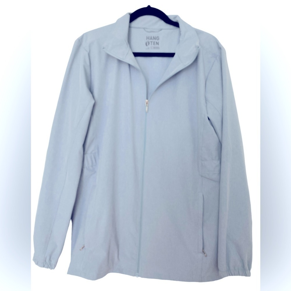 Hang Ten windbreaker size L, Light blue. Elastic in the back, 2 zipper pockets.
